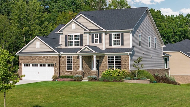 craftsman house featuring an attached garage, brick siding, a shingled roof, driveway, and a front yard