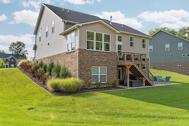 back of property featuring a wooden deck, a patio, stairs, a yard, and brick siding