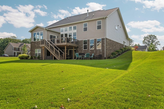 back of house with brick siding, stairway, a lawn, and a wooden deck