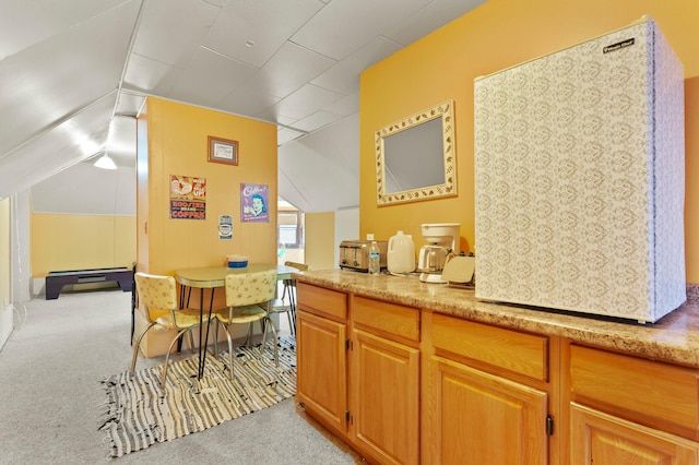 bar featuring lofted ceiling and carpet