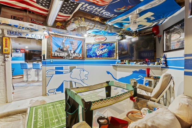 interior space with concrete flooring and ceiling fan