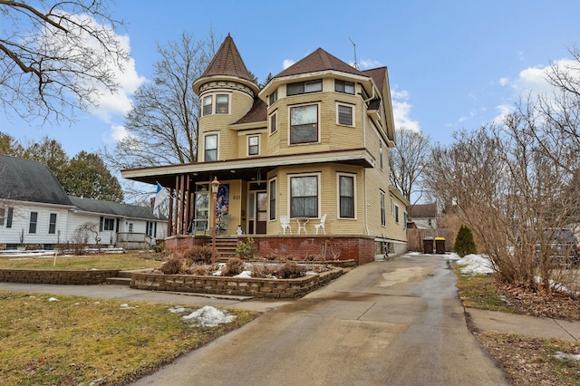 victorian-style house featuring covered porch