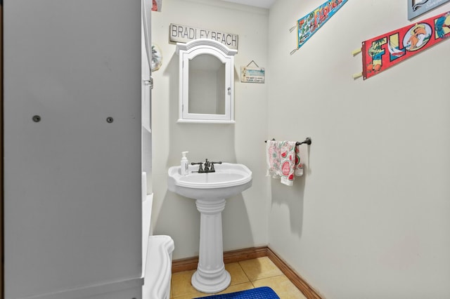 bathroom with baseboards and tile patterned floors