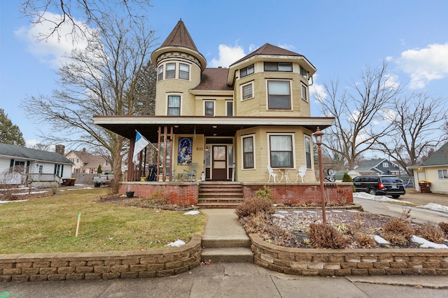 victorian house with covered porch and a front yard