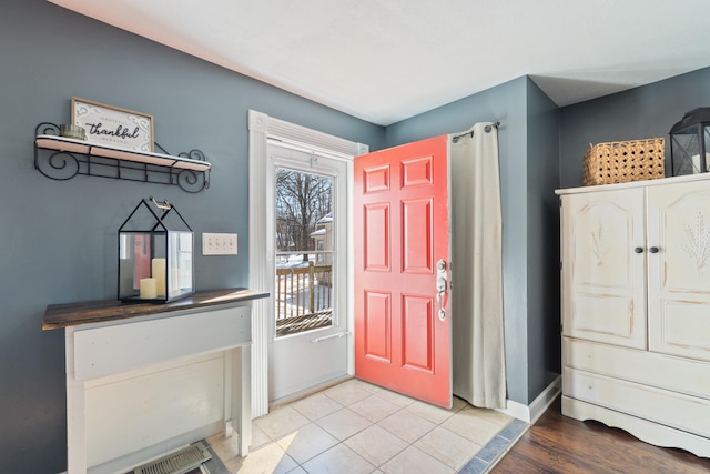 tiled foyer entrance featuring baseboards