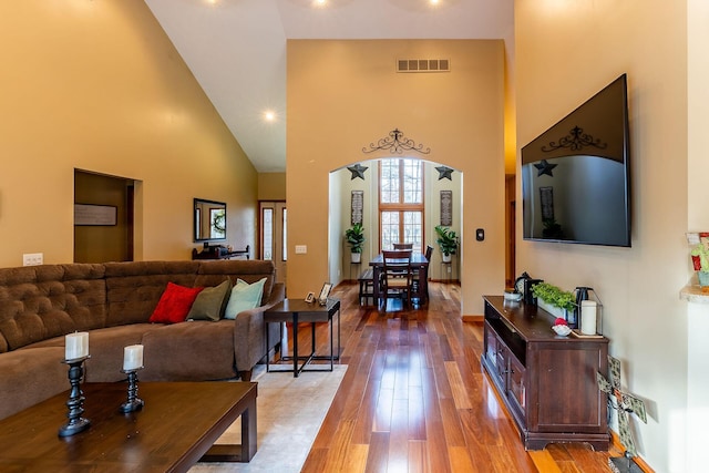 7016 Hyde Park Rd, Whitehall, MI 49461 - living room with a towering ceiling, wood-type flooring, and baseboards