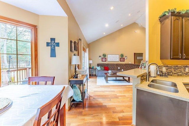 7016 Hyde Park Rd, Whitehall, MI 49461 - dining room with light wood finished floors, high vaulted ceiling, and recessed lighting