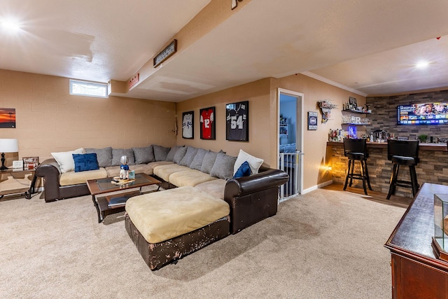 7016 Hyde Park Rd, Whitehall, MI 49461 - carpeted living room featuring wet bar, baseboards, and ornamental molding