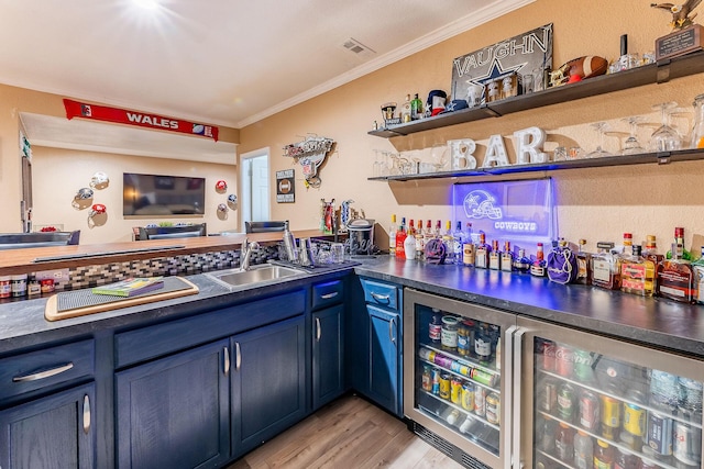 7016 Hyde Park Rd, Whitehall, MI 49461 - indoor bar featuring ornamental molding, light wood-style flooring, and beverage cooler