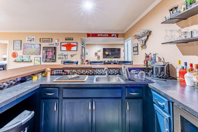 7016 Hyde Park Rd, Whitehall, MI 49461 - kitchen with blue cabinetry, crown molding, open shelves, a sink, and dark countertops
