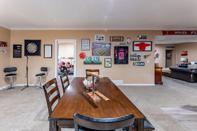 7016 Hyde Park Rd, Whitehall, MI 49461 - carpeted dining space with baseboards and crown molding