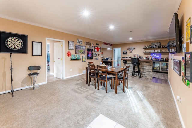 7016 Hyde Park Rd, Whitehall, MI 49461 - dining room with a bar, carpet flooring, recessed lighting, baseboards, and ornamental molding