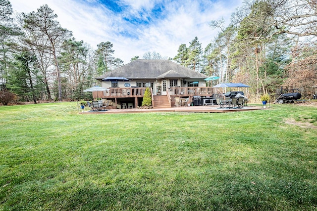 7016 Hyde Park Rd, Whitehall, MI 49461 - back of property featuring a wooden deck, a yard, and outdoor dining area