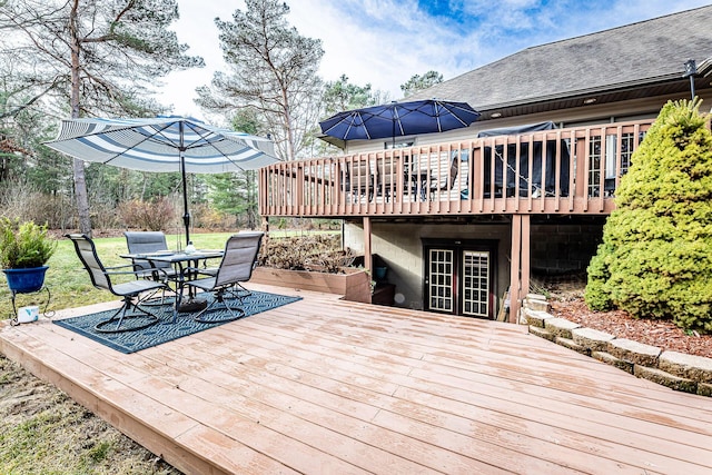 7016 Hyde Park Rd, Whitehall, MI 49461 - wooden terrace featuring french doors, outdoor dining space, and a lawn