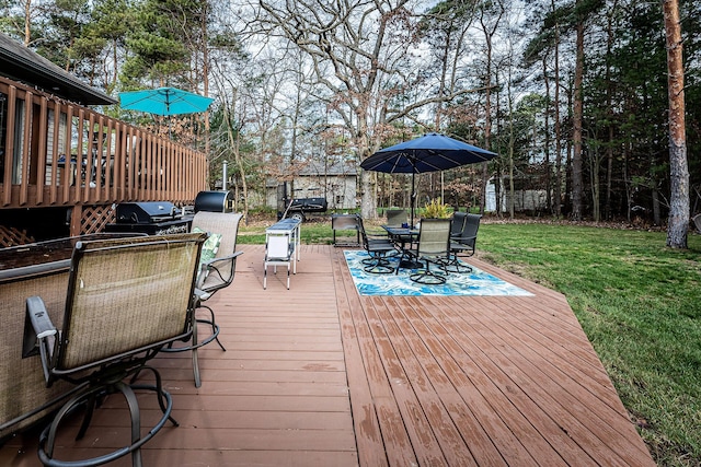 7016 Hyde Park Rd, Whitehall, MI 49461 - wooden deck with outdoor dining space, a yard, view of scattered trees, and area for grilling