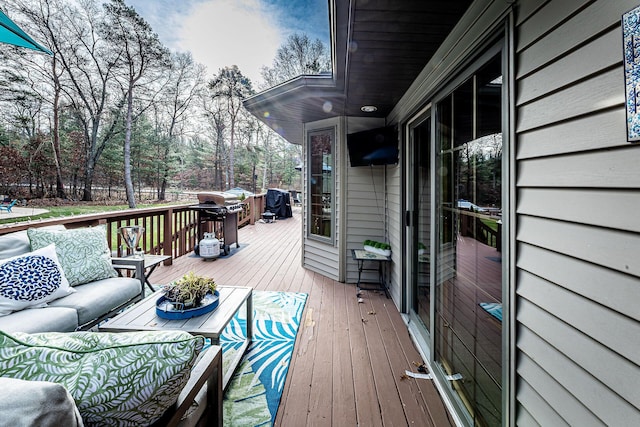 7016 Hyde Park Rd, Whitehall, MI 49461 - wooden terrace with an outdoor living space, a grill, and view of scattered trees