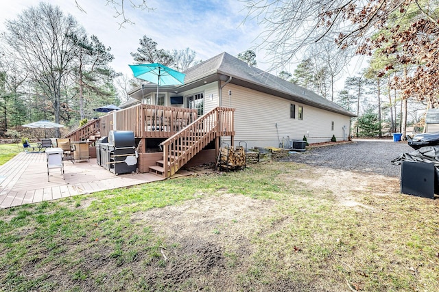 7016 Hyde Park Rd, Whitehall, MI 49461 - rear view of property with a deck, stairway, and cooling unit