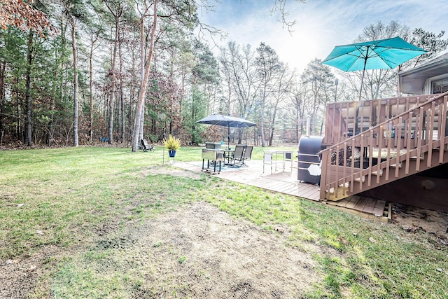 7016 Hyde Park Rd, Whitehall, MI 49461 - view of green lawn featuring a patio, stairs, and a wooden deck