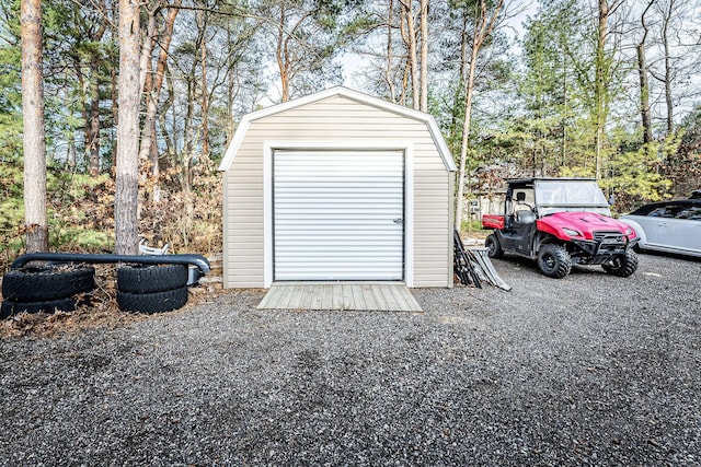 7016 Hyde Park Rd, Whitehall, MI 49461 - garage featuring a storage shed and view of wooded area