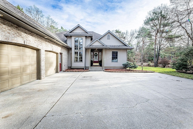 7016 Hyde Park Rd, Whitehall, MI 49461 - view of front facade with concrete driveway, an attached garage, and a shingled roof