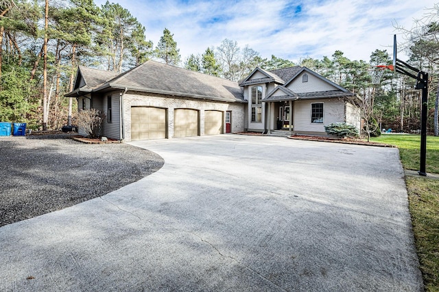 7016 Hyde Park Rd, Whitehall, MI 49461 - view of front of house with an attached garage, concrete driveway, and roof with shingles