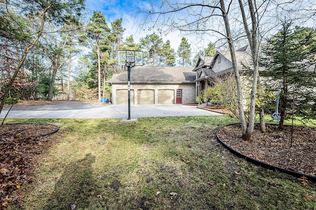 7016 Hyde Park Rd, Whitehall, MI 49461 - rear view of property with driveway, a yard, a shingled roof, a garage, and brick siding