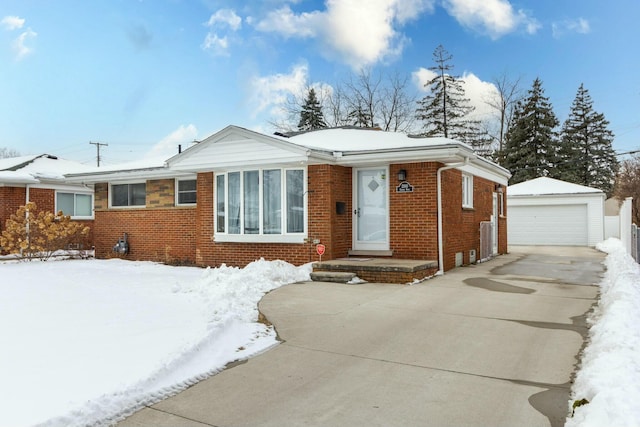 view of front of property with a garage, brick siding, and an outdoor structure