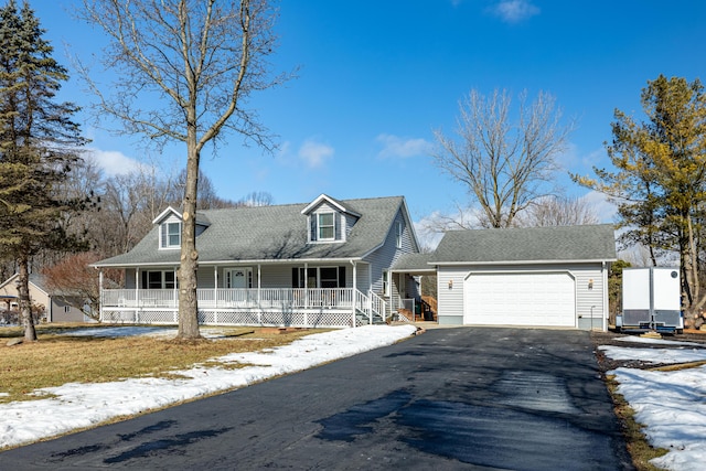 cape cod-style house with a porch, driveway, and a garage