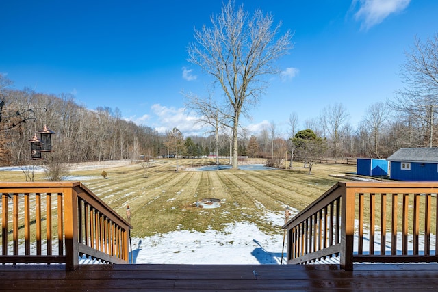 deck with a shed and an outdoor structure