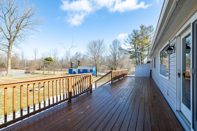 wooden terrace with an outbuilding and a yard