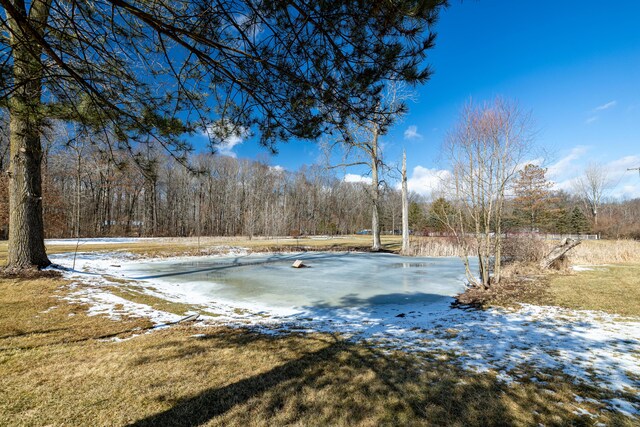 exterior space featuring a wooded view