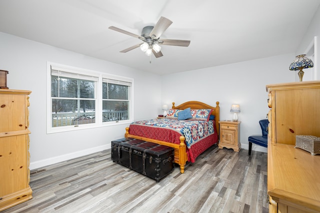 bedroom featuring light wood-type flooring, visible vents, and baseboards