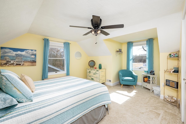 carpeted bedroom featuring vaulted ceiling, a textured ceiling, baseboards, and ceiling fan