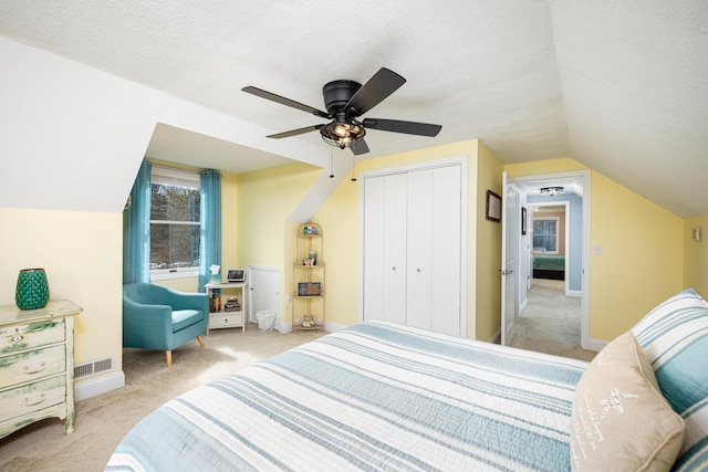 bedroom featuring carpet floors, baseboards, and a textured ceiling