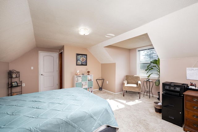 bedroom with light carpet, vaulted ceiling, and baseboards