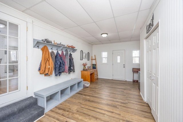 mudroom with a drop ceiling and wood finished floors