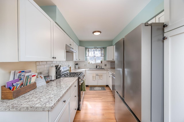 kitchen featuring appliances with stainless steel finishes, white cabinetry, and under cabinet range hood