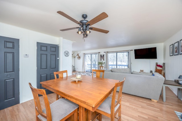 dining area featuring light wood-type flooring and ceiling fan