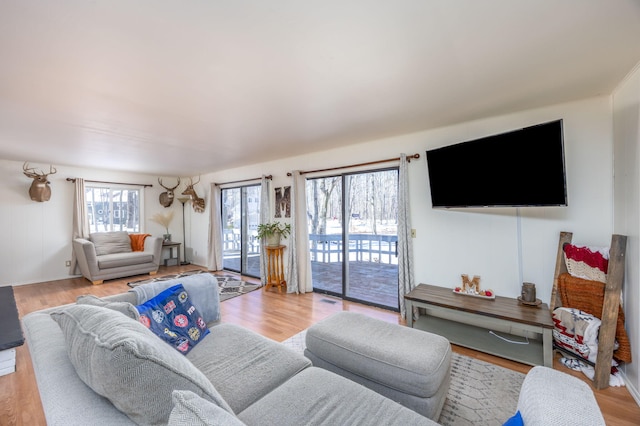 living room with light wood-style floors and visible vents