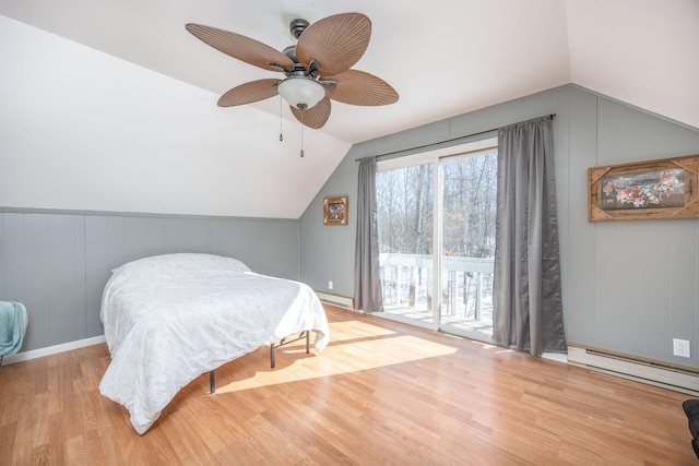 bedroom with lofted ceiling, light wood-type flooring, and access to outside