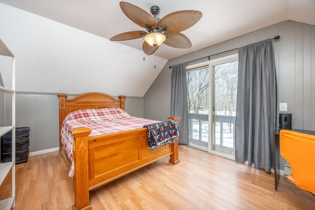 bedroom with access to outside, multiple windows, and light wood finished floors