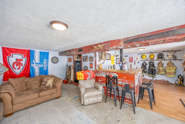 living area featuring a textured ceiling and a dry bar