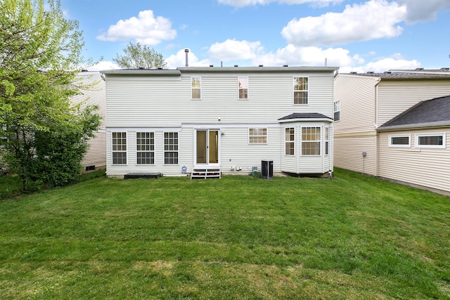 3048 Turnberry Ln, Ann Arbor, MI 48108 - rear view of property featuring entry steps, a yard, and central AC
