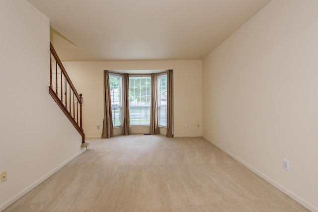 3048 Turnberry Ln, Ann Arbor, MI 48108 - unfurnished room with stairway, light carpet, and baseboards