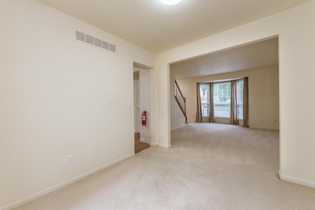 3048 Turnberry Ln, Ann Arbor, MI 48108 - empty room featuring carpet flooring, stairs, and baseboards