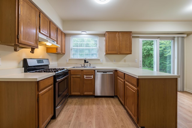 3048 Turnberry Ln, Ann Arbor, MI 48108 - kitchen featuring stainless steel appliances, a sink, a peninsula, under cabinet range hood, and light countertops