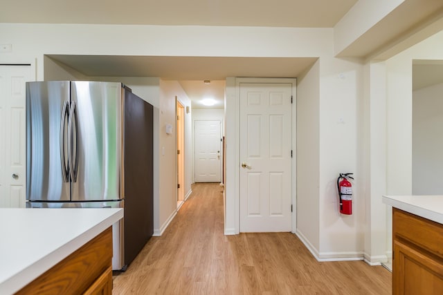 3048 Turnberry Ln, Ann Arbor, MI 48108 - kitchen featuring freestanding refrigerator, light wood-style flooring, brown cabinets, and light countertops