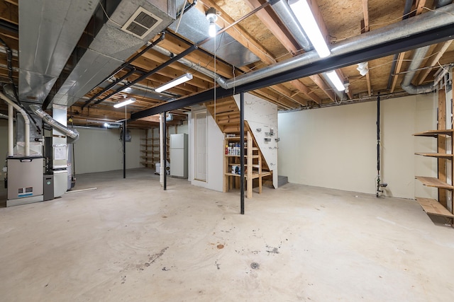 3048 Turnberry Ln, Ann Arbor, MI 48108 - unfinished below grade area with stairs, freestanding refrigerator, and heating unit