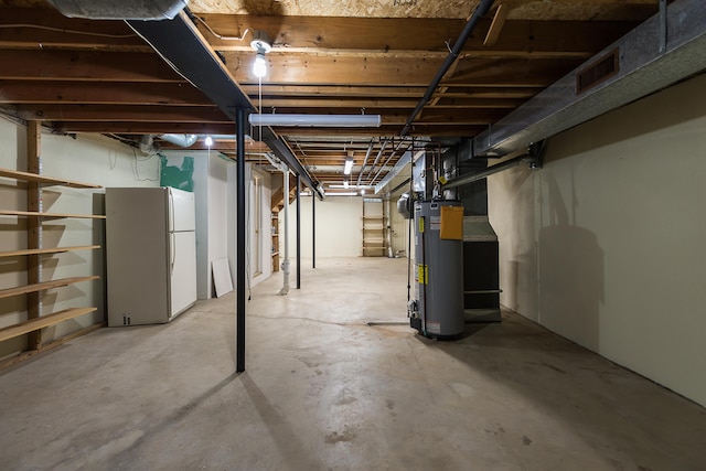 3048 Turnberry Ln, Ann Arbor, MI 48108 - unfinished basement with freestanding refrigerator and gas water heater