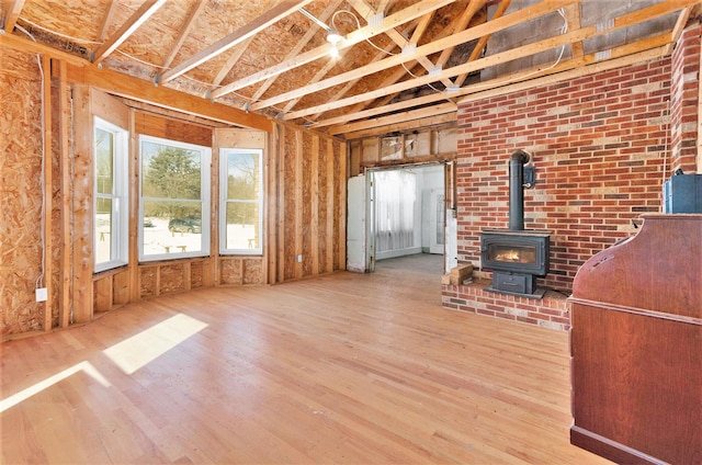 11333 Stony Creek Rd, Milan, MI 48160 - unfurnished living room featuring wood finished floors and a wood stove